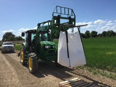 A fork lift may be used to easily load the drop spreader.